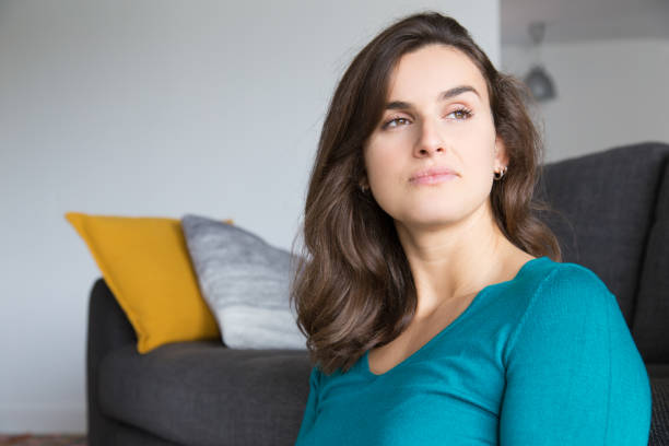 istock Pensive dreamy girl resting at home 1128131946
