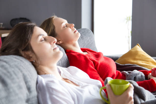 istock Serene roommates resting on couch over cup of tea 1128131948