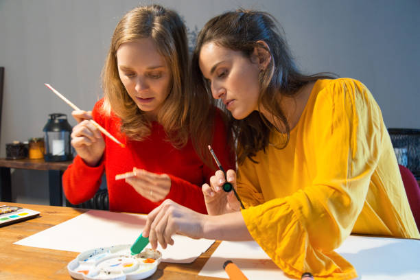 istock Serious art master showing how to work with palette 1128131960