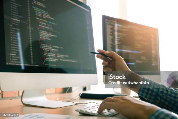 Developing Programming Working In A Software Engineers Code Tech Applications On Desk In Office Room Stock Photo - Download Image Now