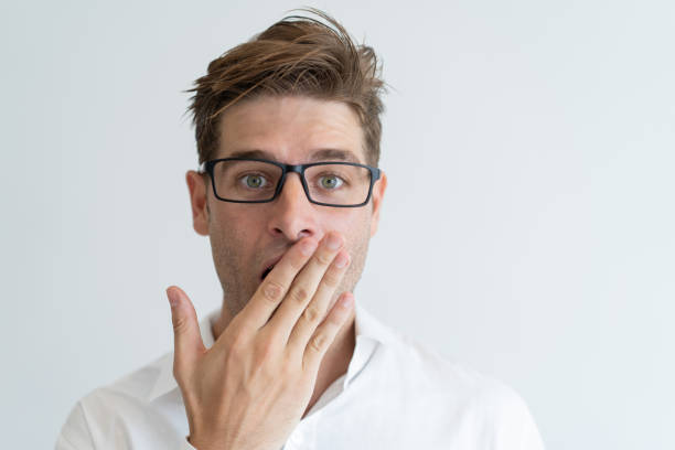 istock Surprised handsome man covering mouth with hand 1128132587