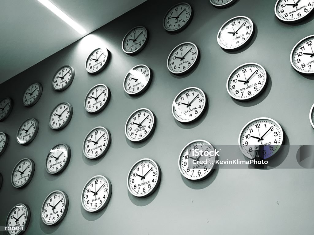 Wall of clocks for world cities and time zones Many clocks on a wall for cities around the world Clock Stock Photo