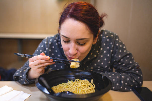 istock Enjoying delicious ramen in noodle shop 1128142407