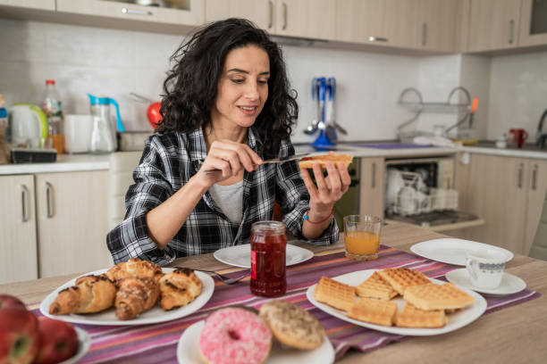 istock Woman enjoying breakfast at home 1128147246