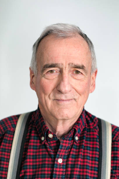 Smiling Senior man in his late 70s studio head shot Smiling Senior man in his late 70s studio head shot, wearing suspenders and a red plaid shirt. identity photos stock pictures, royalty-free photos & images