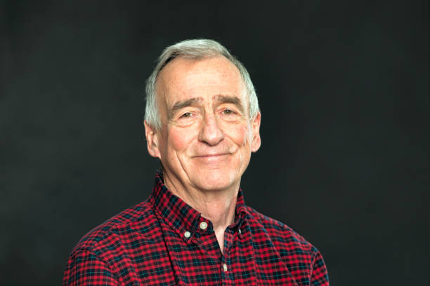 istock Satisfied Senior man in his late 70s studio portrait with dark background 1128149818
