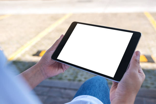 istock a woman holding black tablet pc with blank white screen 1128153037