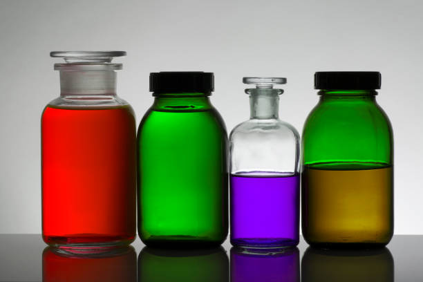 istock Liquid in laboratory bottles. Scientific biochemical laboratory. Colorful liquid. Isolated on white background,  a group of bottles. Test tubes. 1128155706