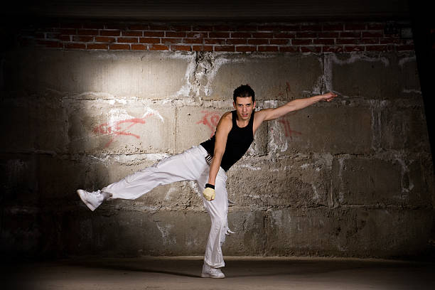 istock Hip hop men dancing in modern style over grey wall 112815643