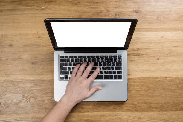 istock Working on laptop. man working on computer. Top view of person in modern office interior. 1128159681