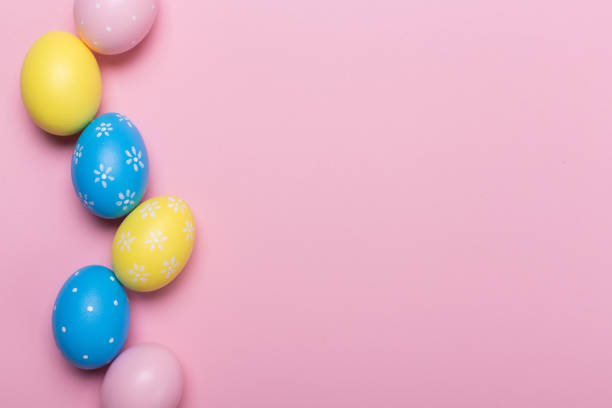 istock Colorfull easter eggs in nest on pastel color background with space. Concept 1128159835