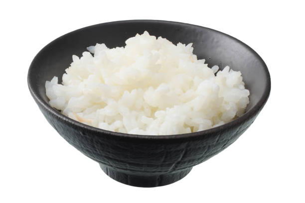 istock White rice in black bowl isolated on white background. 1128161757