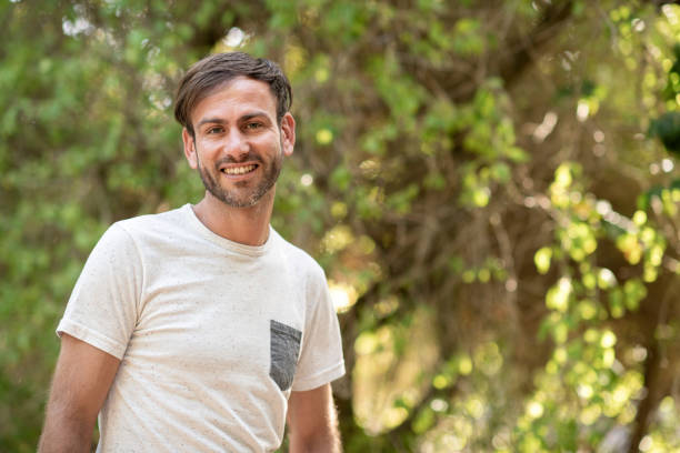 istock Portrait of smiling man standing in yard 1128163537