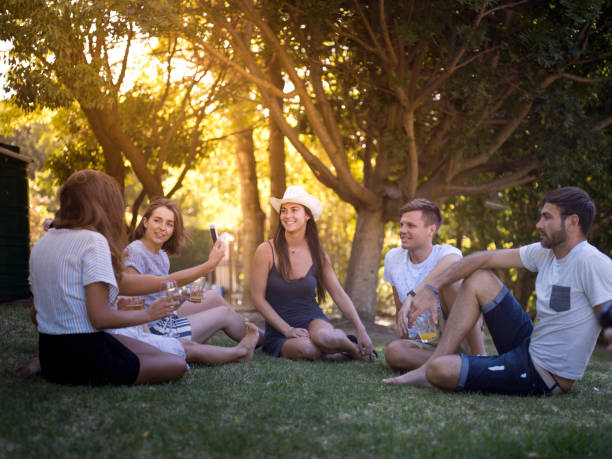 istock Woman taking selfie while sitting with friends 1128163905