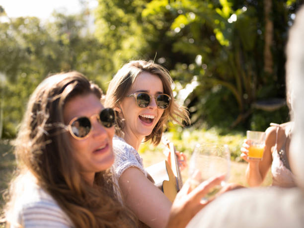 istock Happy friends enjoying in picnic at back yard 1128164755