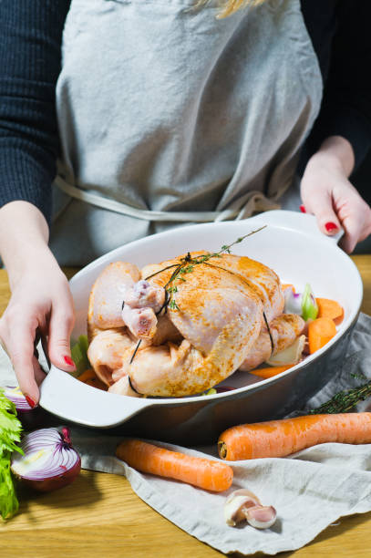 istock The chef is holding a pan with whole marinated chicken 1128165011
