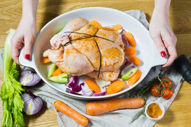 istock The chef is holding a pan with whole marinated chicken 1128165018