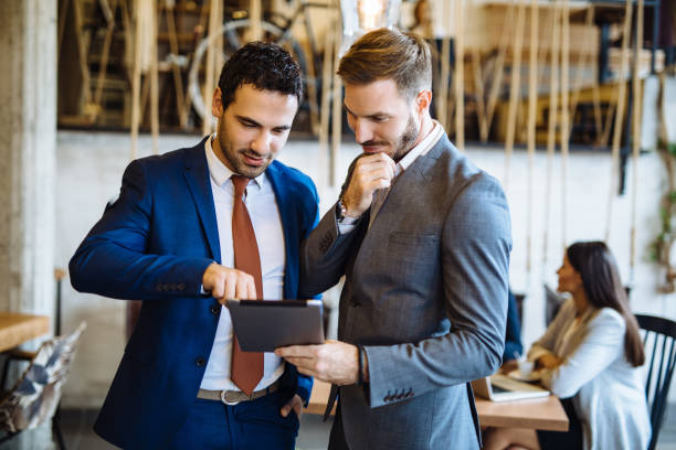 istock Two young businessmen discussing business strategy using digital tablet 1128171261