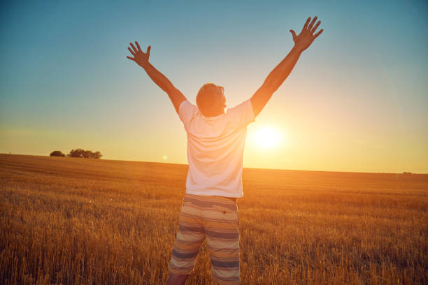 istock Cute young woman jumping in a wheat field. 1128174170