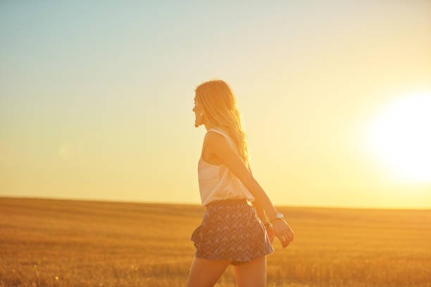 istock Cute young woman jumping in a wheat field. 1128175134