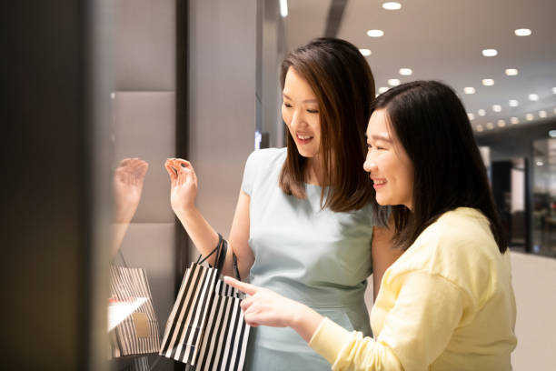istock Two Asian women window shopping 1128175816