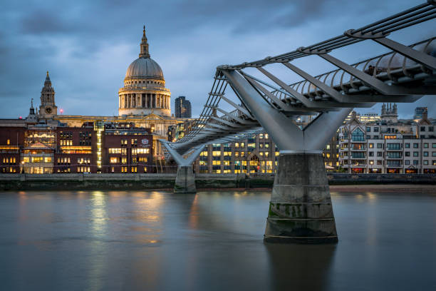 istock Millenium Bridge leading to St Paul's Cathedral at twilight and blurred commuters walking-stock image 1128177720