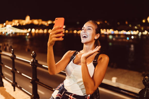 istock Beautiful woman in Budapest talking on video call 1128177854