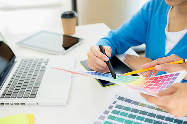 istock Graphic design and color swatches and pens on a desk. Architectural drawing with work tools and accessories. 1128180584