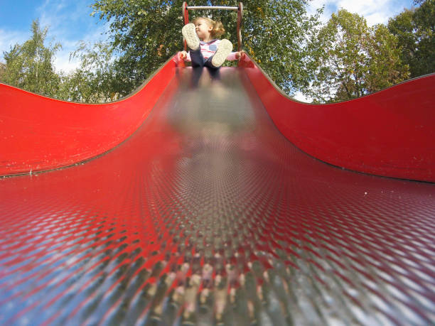photo of Red plastic pipe with curves in a playground, view from the inside. abstract lights and textures. for design. space for your textview from the inside. abstract lights and textures. for design. space for your text