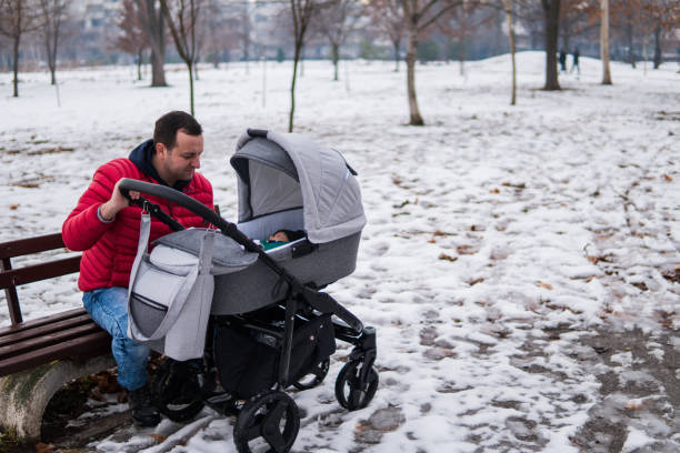 istock happy baby with his father outdoors in winter 1128184132
