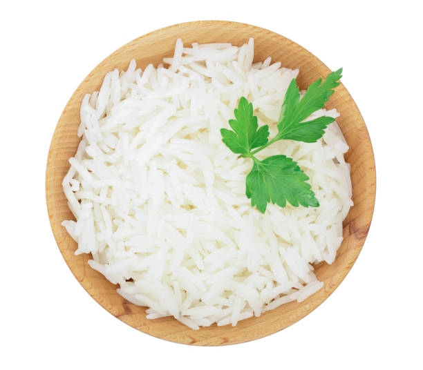 istock rice in a wooden bowl isolated on white background. Top view. Flat lay 1128184591