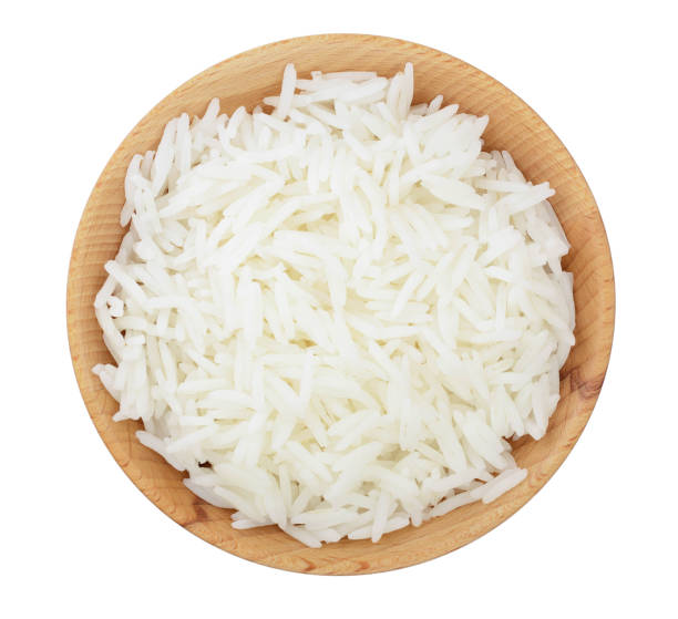 istock rice in a wooden bowl isolated on white background. Top view. Flat lay 1128184607