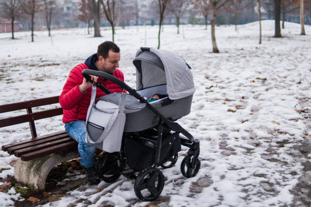 istock happy baby with his father outdoors in winter 1128185809