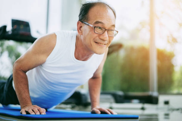 Senior man push up in fitness gym. Mature healthy lifestyle. Senior man push up in fitness gym. Mature healthy lifestyle. senior bodybuilders stock pictures, royalty-free photos & images