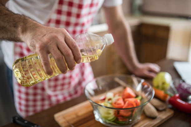 istock Pouring oil on salad 1128186859