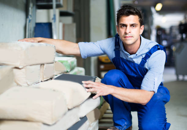 istock Shop assistant is checking bags with cement 1128187829