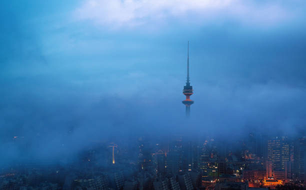 beautiful view of kuwait city on a foggy winter evening stock photo