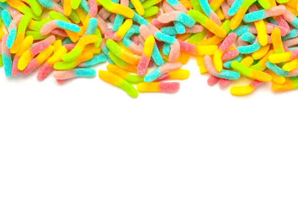 istock Frame of assorted gummy candies isolated on white. Top view. Space for text or design. 1128188897