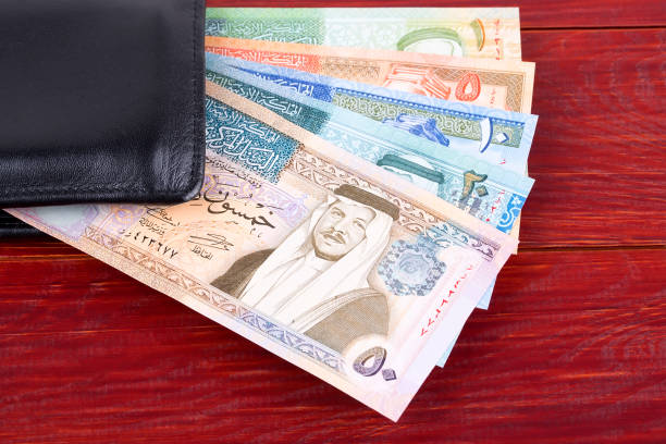 Jordanian Dinar in the black wallet Jordanian Dinar in the black wallet on a wooden background dinar stock pictures, royalty-free photos & images