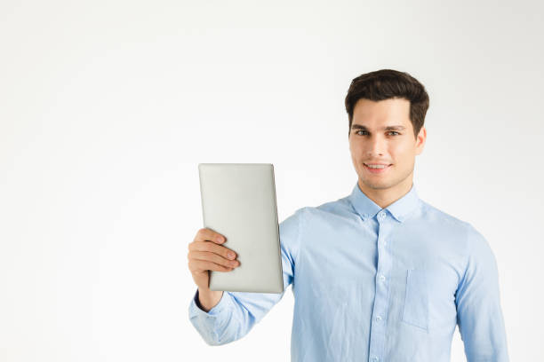 istock Happy business man presenting tablet. 1128191791