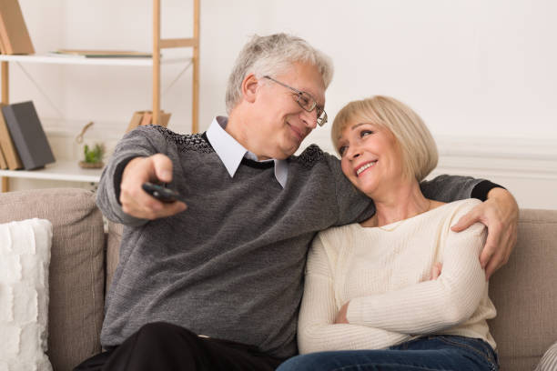 istock Relaxed senior couple watching television at home 1128192855
