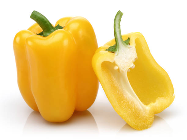 istock Whole and half yellow bell peppers isolated 1128193108
