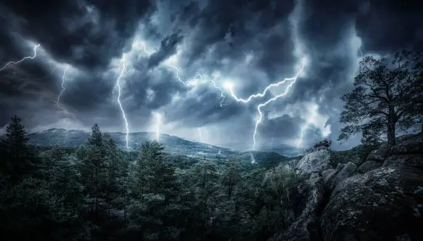 Photo of Lightning thunderstorm flash in the mountains. Concept on topic weather, cataclysms (hurricane, Typhoon, tornado, storm)