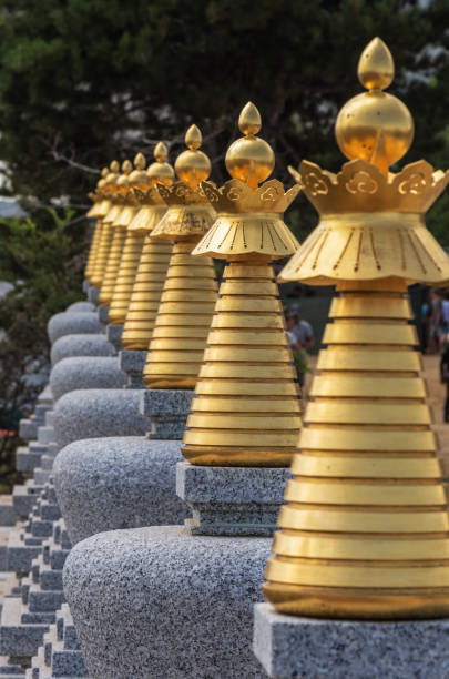 istock Eight small granite Buddhist stupas in a row, shallow depth of field 1128195073