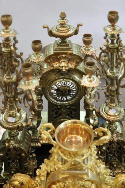 Photo of Different clock and candle holders bronze at a flea market