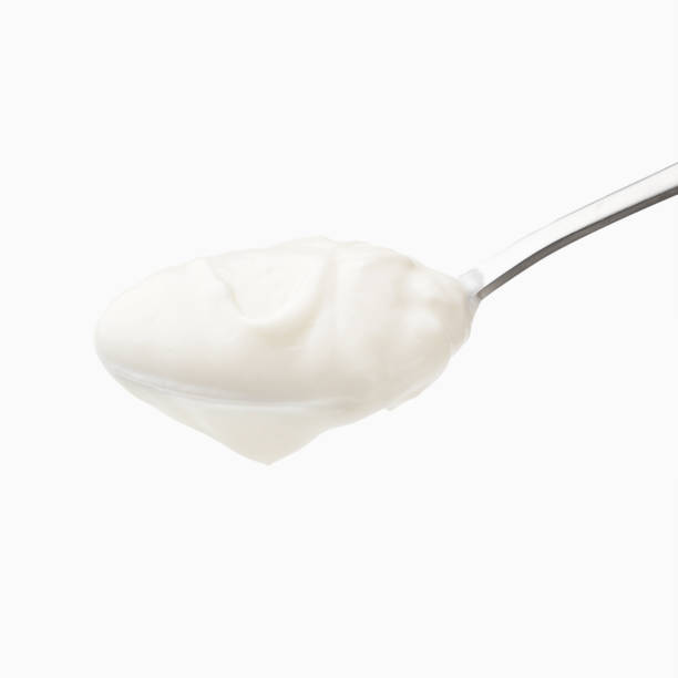 istock Yogurt in spoon isolated 1128195758