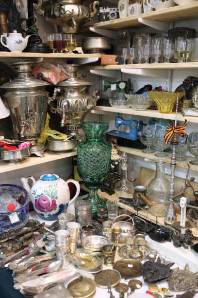 istock Many different things: vases, samovar, glasses, spoons at the flea market 1128195786