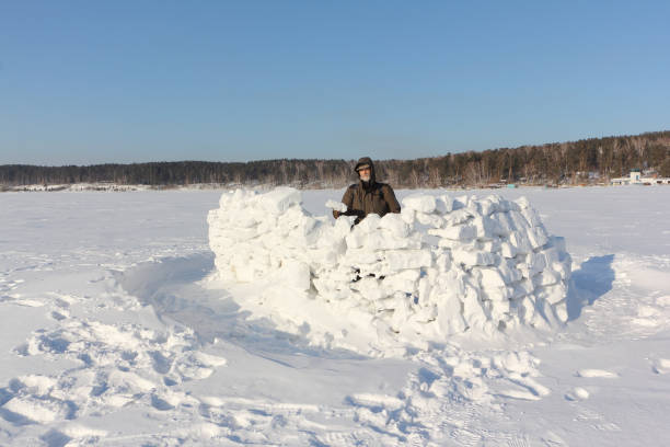 istock Man building a snow wall, Siberia, Russia 1128196227