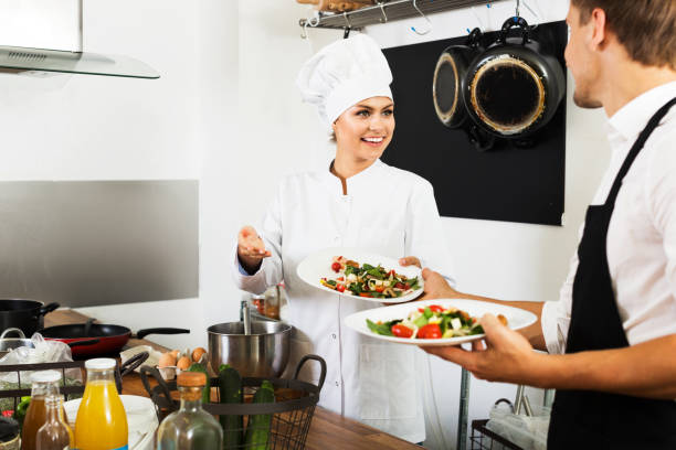 istock Chef giving salad to waitress 1128199971