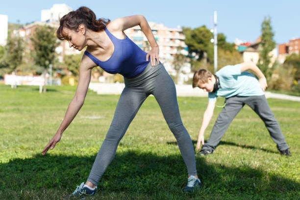 istock Mother and son stretching outdoors 1128200304